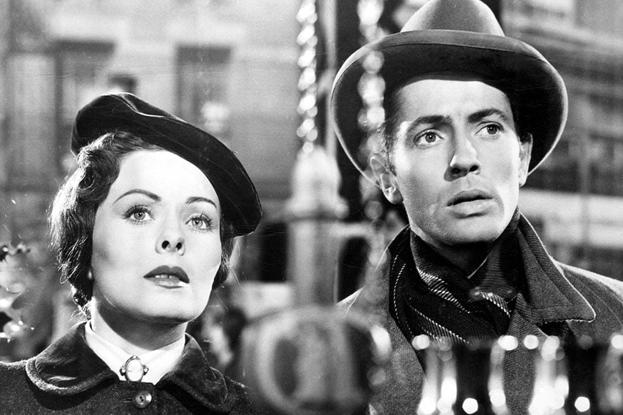 a black and white movie still depicting a lady and a gentleman during Christmas